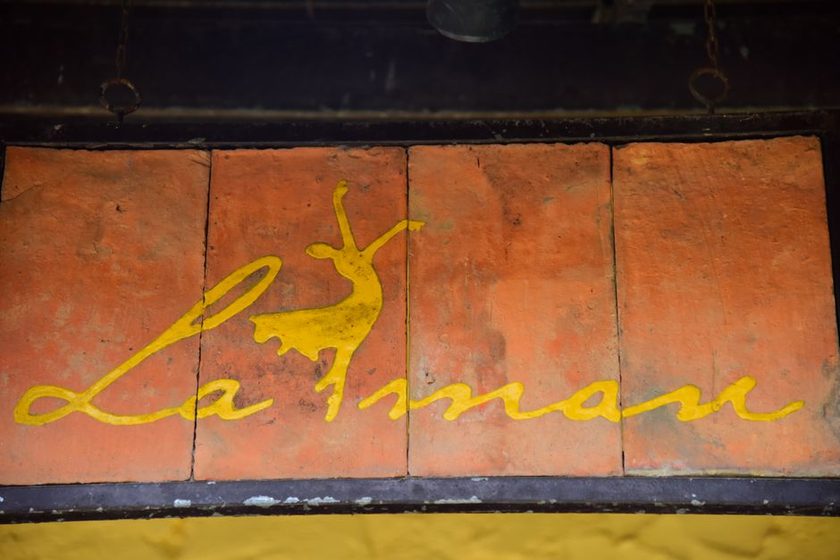 Sheet of loose gold leaf being laid onto sized lettering